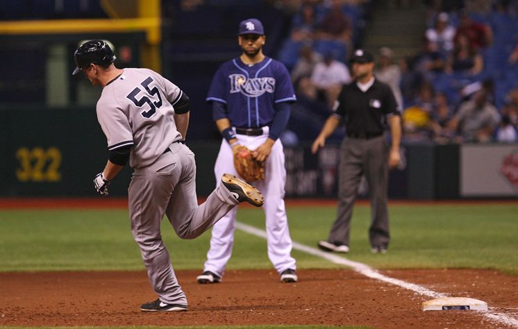 Lyle Overbay trots past Rays first baseman James Loney after putting the Yankees ahead 4-3 with a two-out home run in the 11th inning. (Daniel Wallace/Times)