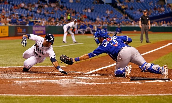 J.P. Arencibia stretches but does not initially tag Sean Rodriguez (Photo by J. Meric/Getty Images)