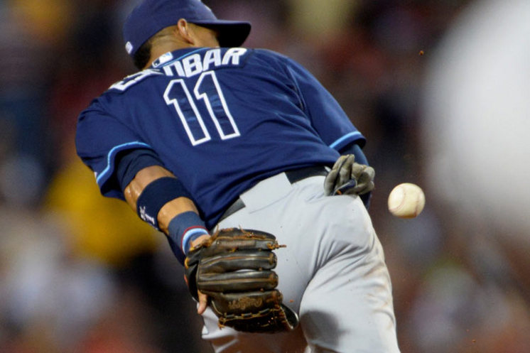 Rays shortstop Yunel Escobar makes a behind-the-back glove toss to start a double play ending the fourth inning of Wednesday's game against the Boston Red Sox at Fenway Park. 