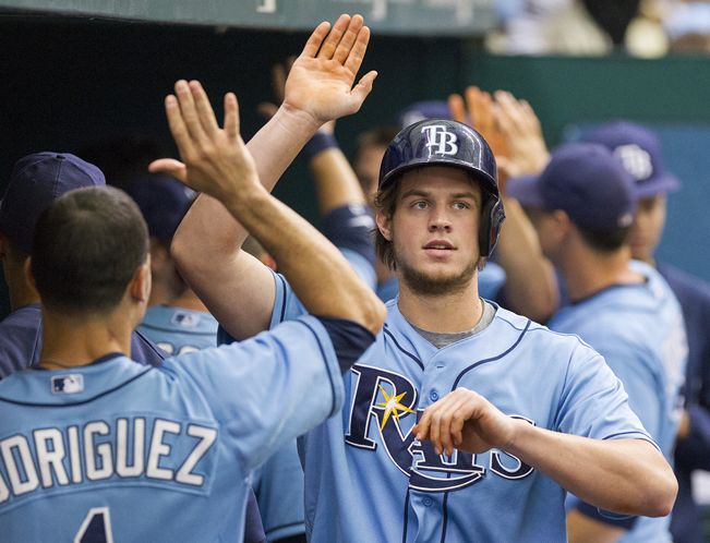 Rookie Wil Myers gets high-fived in the dugout after putting the Rays ahead with a two-run home run off Guillermo Moscoso in the first inning. (Photo courtesy of James Borchuck/Tampa Bay Times)