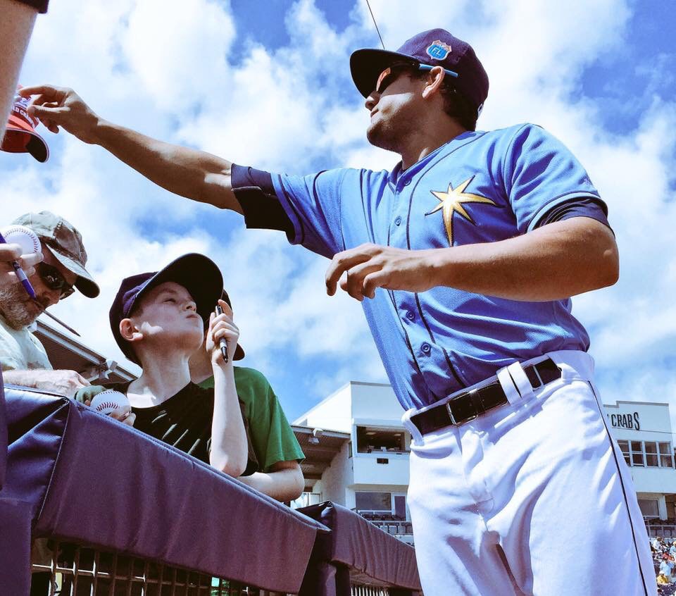 Outfielder Mikie Mahtook signs autographs for fans at Charlotte Sports Park for the last time this Spring. (Photo Credit: Tampa Bay Rays)