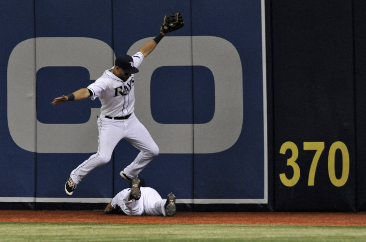 Kevin Kiermaier jumps over Steven Souza Jr. after Souza made a leaping catch of a fly ball hit by Baltimore Orioles' Chris Davis. (Photo Credit: AP Photo/Steve Nesius)